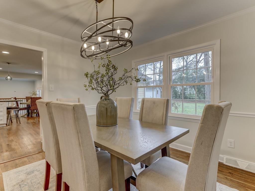 4234 Chevington Road Charlotte, NC 28226 - Photo 9 of 46 a view of a dining room with furniture wooden floor and chandelier