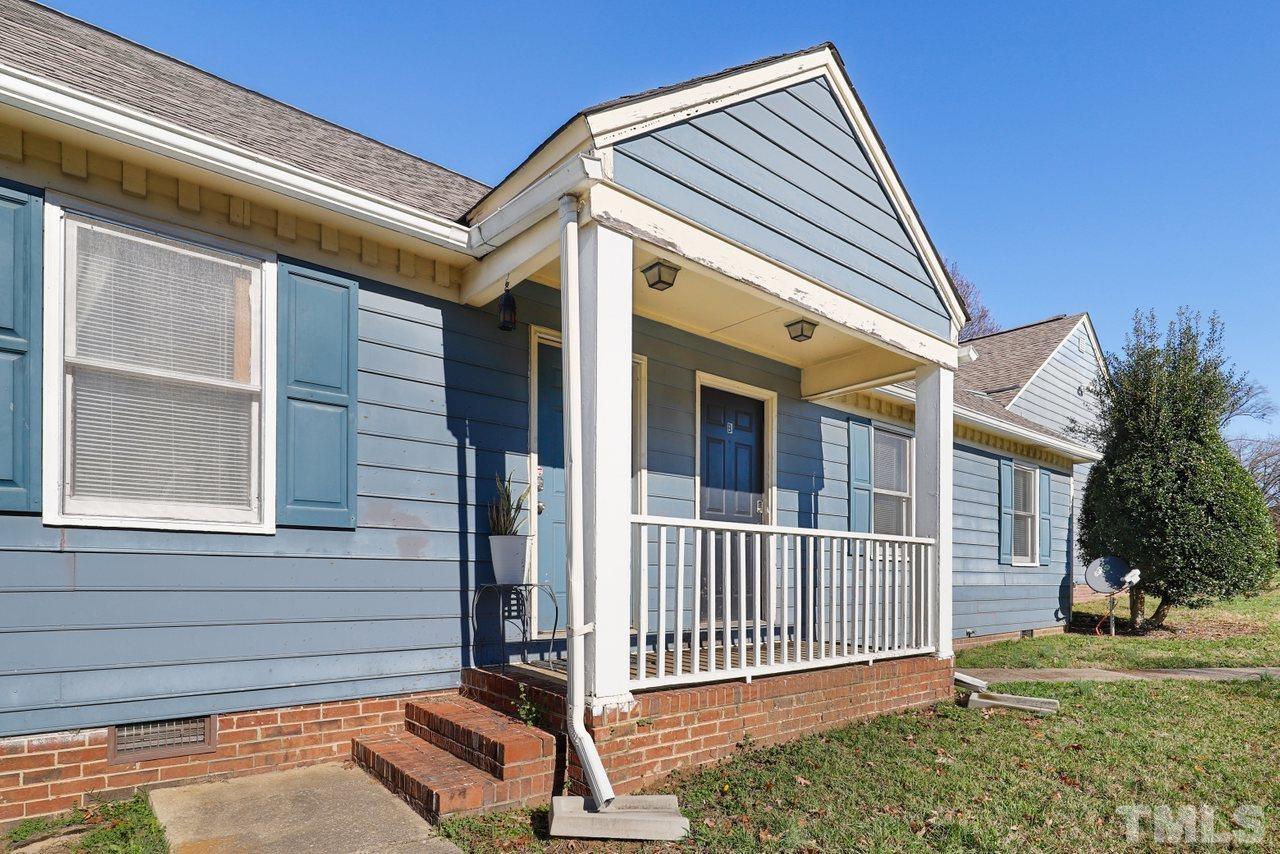 4541 Hargrove Road Raleigh, NC 27604 - Photo 2 of 24 a view of a house with a small yard and wooden fence and floor to ceiling window