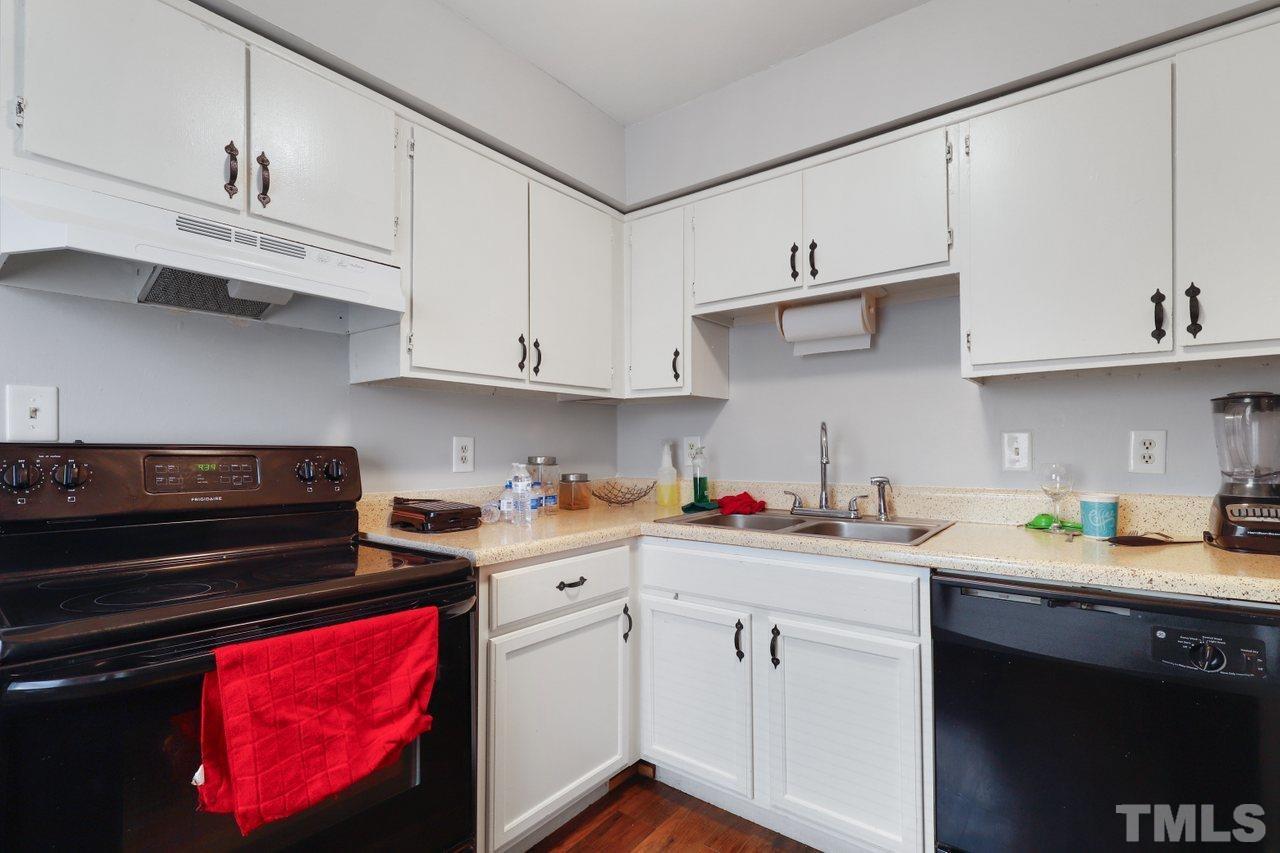 4541 Hargrove Road Raleigh, NC 27604 - Photo 11 of 24 a kitchen with stainless steel appliances granite countertop a sink dishwasher stove and cabinets