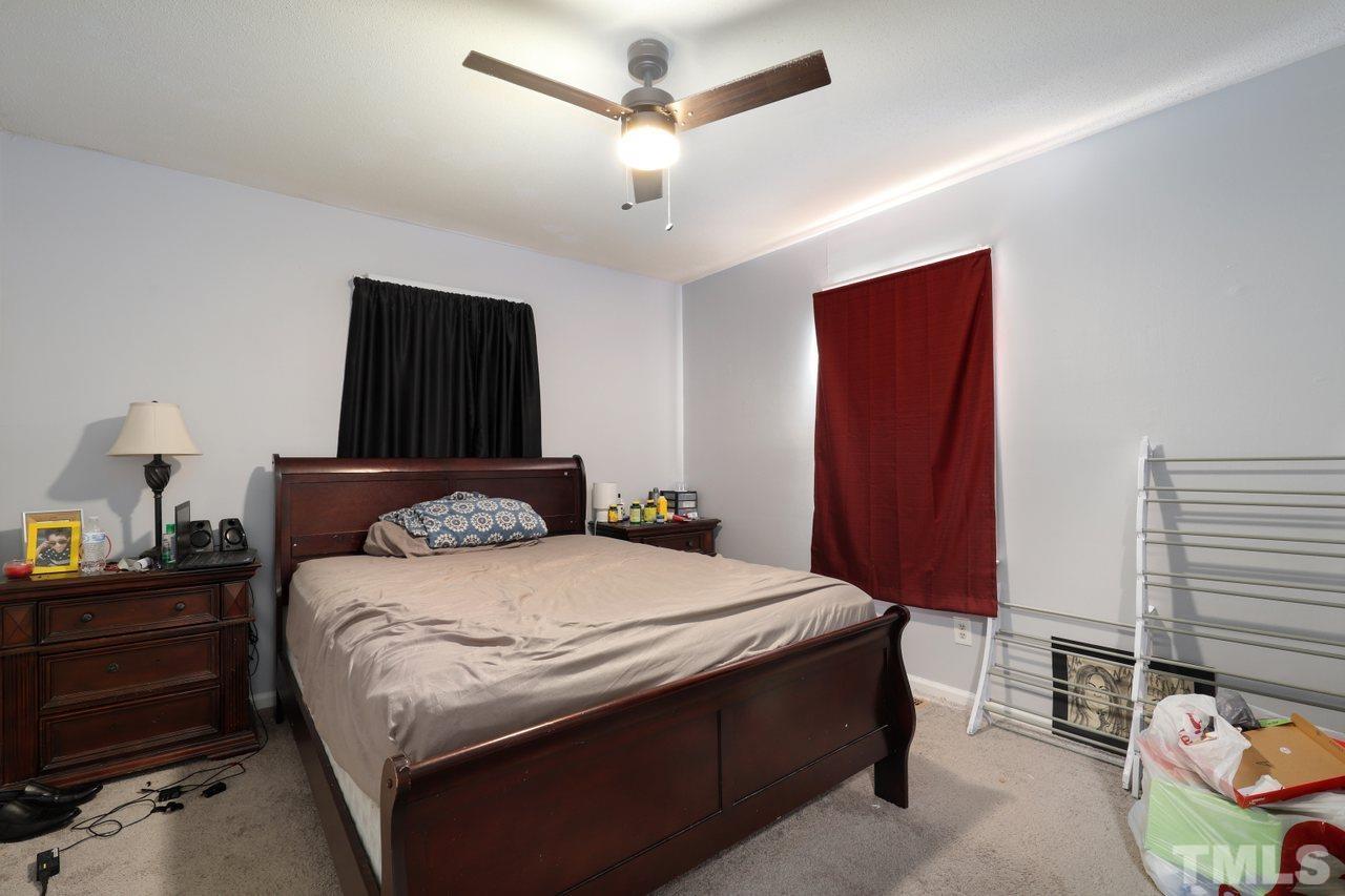 4541 Hargrove Road Raleigh, NC 27604 - Photo 14 of 24 a bedroom with a bed and a chandelier