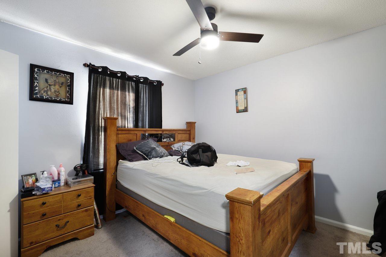 4541 Hargrove Road Raleigh, NC 27604 - Photo 15 of 24 a bedroom with a bed and a chandelier