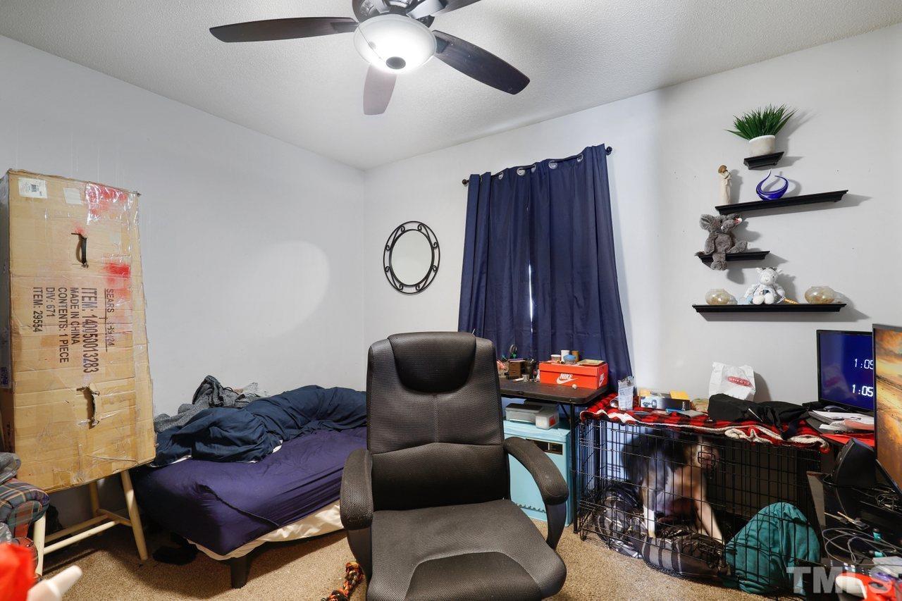 4541 Hargrove Road Raleigh, NC 27604 - Photo 19 of 24 a living room with furniture and a lamp