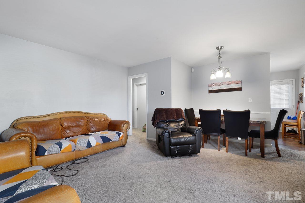4541 Hargrove Road Raleigh, NC 27604 - Photo 3 of 24 a living room with furniture a couch and a chandelier