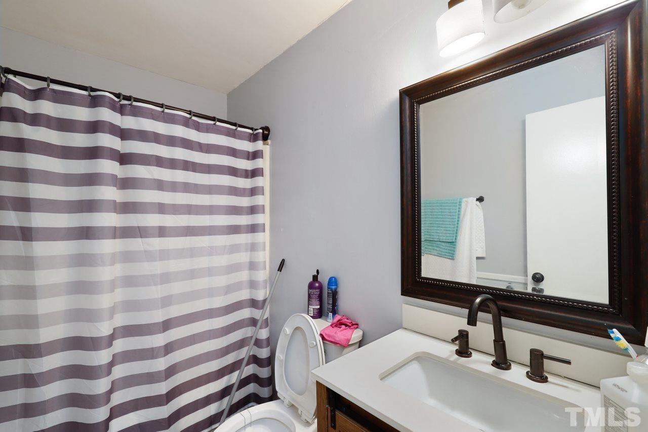 4541 Hargrove Road Raleigh, NC 27604 - Photo 21 of 24 a bathroom with a sink and a mirror
