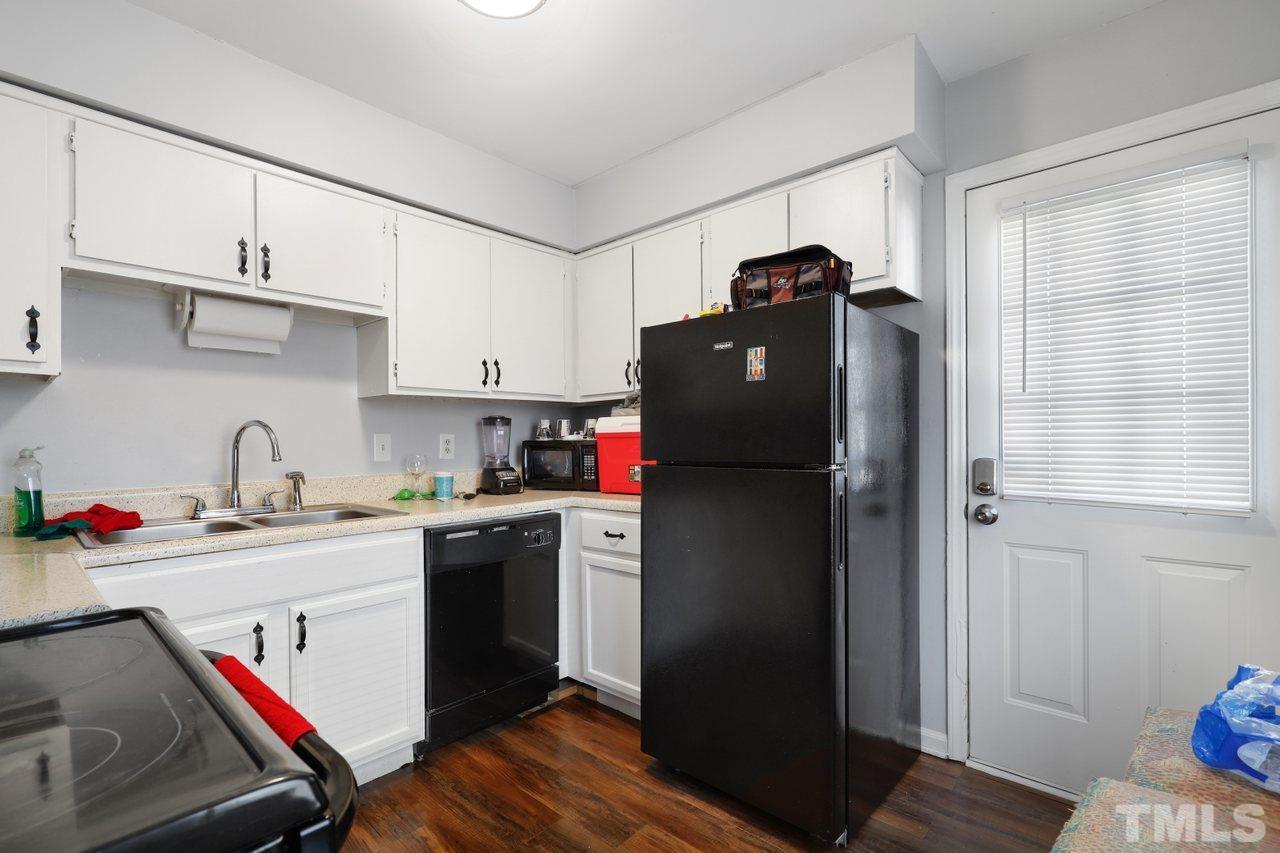4541 Hargrove Road Raleigh, NC 27604 - Photo 10 of 24 a kitchen with a refrigerator and a stove top oven