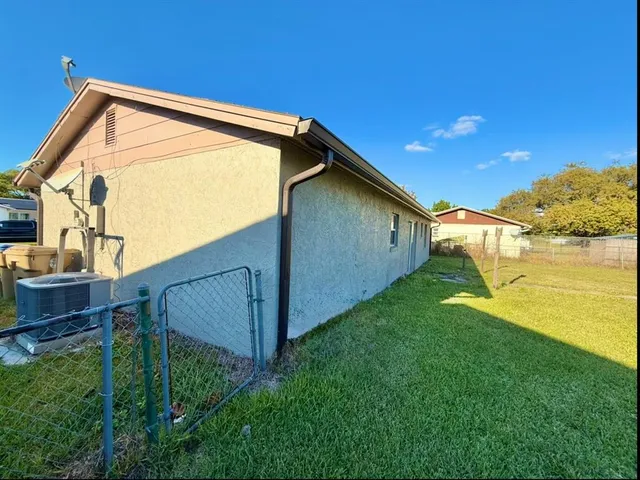 a backyard of a house with wooden fence