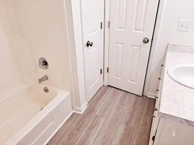 a bathroom with a bathtub a toilet and a shower