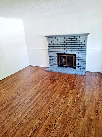 a view of empty room with a fireplace