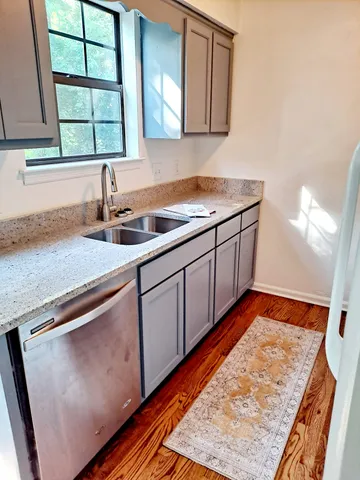 a kitchen with stainless steel appliances granite countertop a sink stove and cabinets