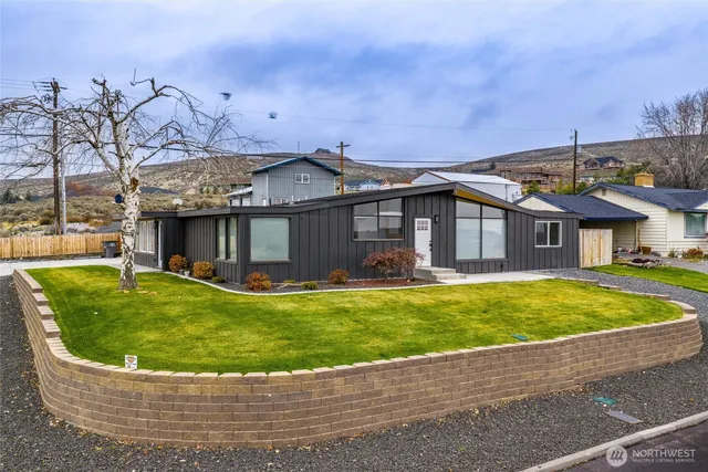 a view of a house with a swimming pool and a yard
