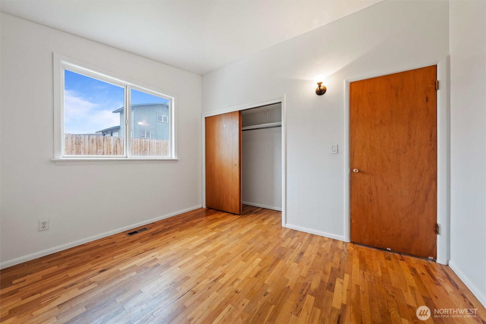 401 Statter Road Ephrata, WA 98823 - Photo 12 of 40 a view of an empty room with wooden floor and a window