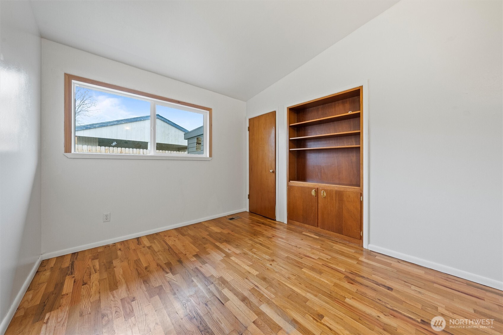 401 Statter Road Ephrata, WA 98823 - Photo 14 of 40 a view of an empty room with a window and wooden floor