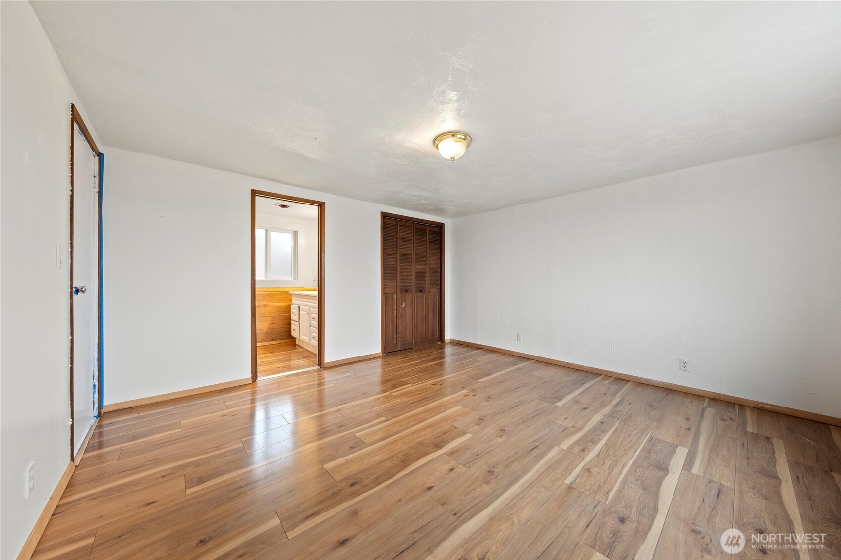 401 Statter Road Ephrata, WA 98823 - Photo 32 of 40 a view of an empty room with wooden floor and a window