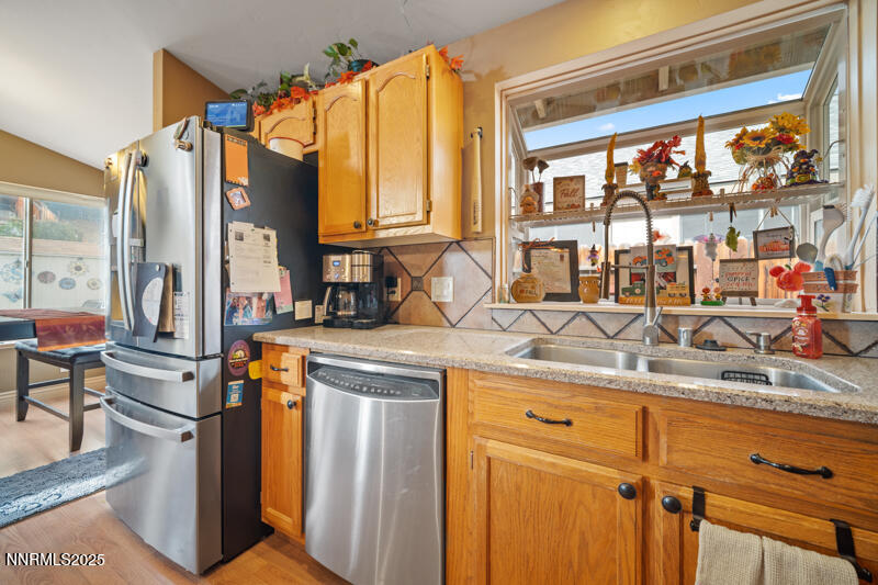2215 Gatewood Drive Reno, NV 89523 - Photo 18 of 37 a kitchen with stainless steel appliances granite countertop a sink and a refrigerator