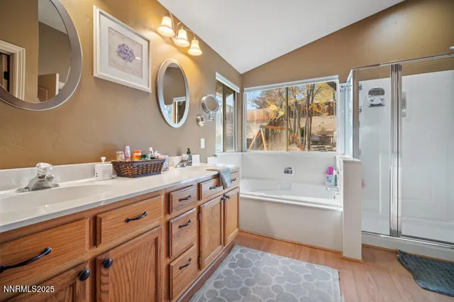a bathroom with a tub sink and mirror