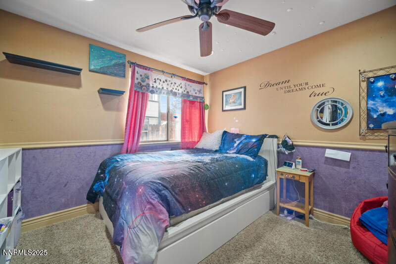 2215 Gatewood Drive Reno, NV 89523 - Photo 26 of 37 a bedroom with a bed and a chandelier