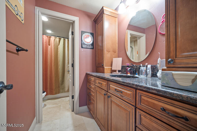 2215 Gatewood Drive Reno, NV 89523 - Photo 28 of 37 a bathroom with a double vanity sink and a mirror