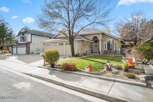 a front view of a house with a yard and potted plants