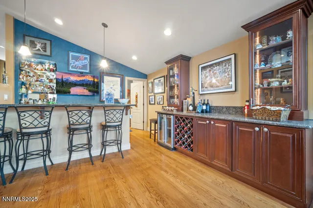 a open kitchen with stainless steel appliances granite countertop a refrigerator and wooden cabinets