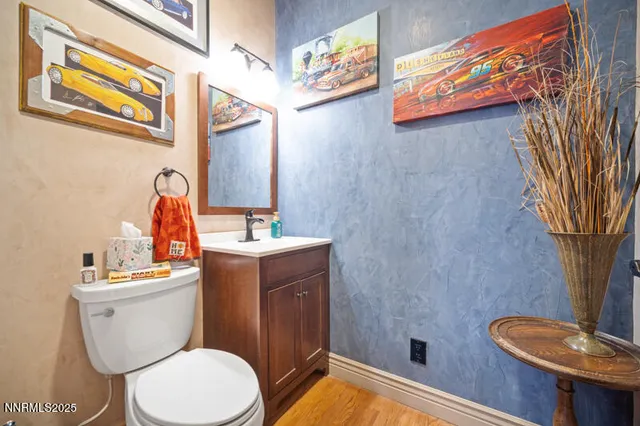 a white toilet sitting next to a bathroom sink and tub