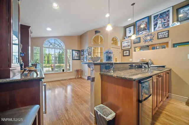 a kitchen with stainless steel appliances granite countertop a stove and a wooden floors