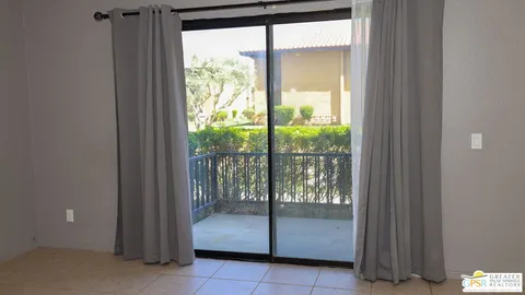 a room with a large window and an outdoor space