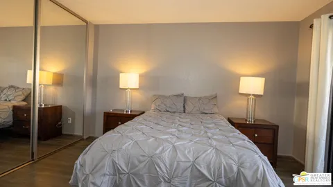 a bedroom with a bed and a lamp