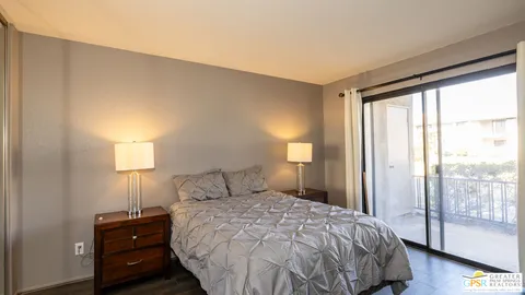 a bedroom with a bed and a lamp