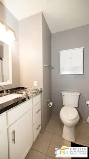 a bathroom with a toilet sink and mirror