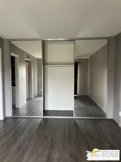 an empty room with wooden floor and a window