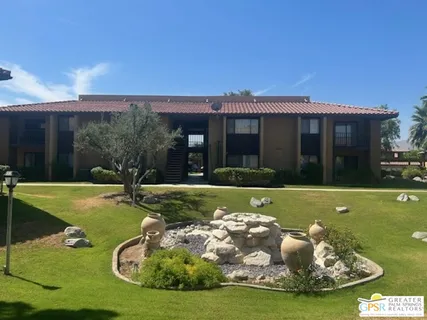 a view of a house with backyard swimming pool and sitting area