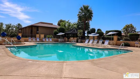 a view of a swimming pool with outdoor seating
