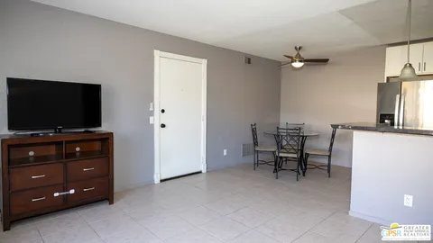a view of a livingroom with furniture and a flat screen tv