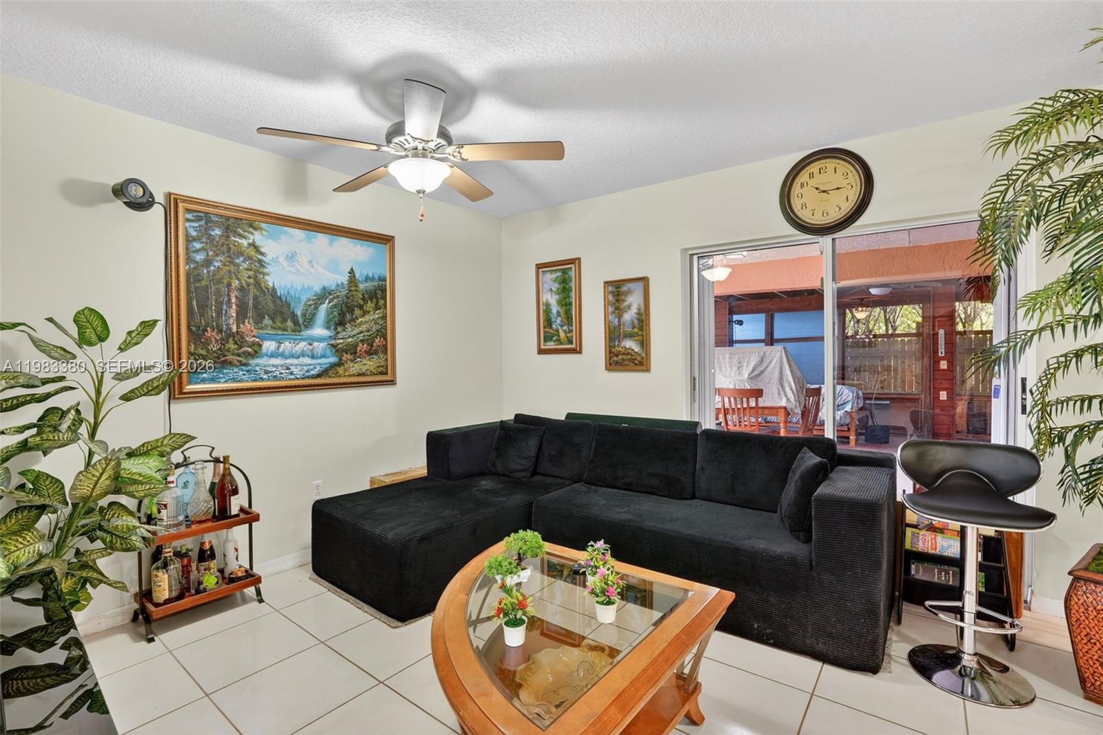 15672 Southwest 91st Lane Miami, FL 33196 - Photo 15 of 47 a living room with furniture a clock and a rug