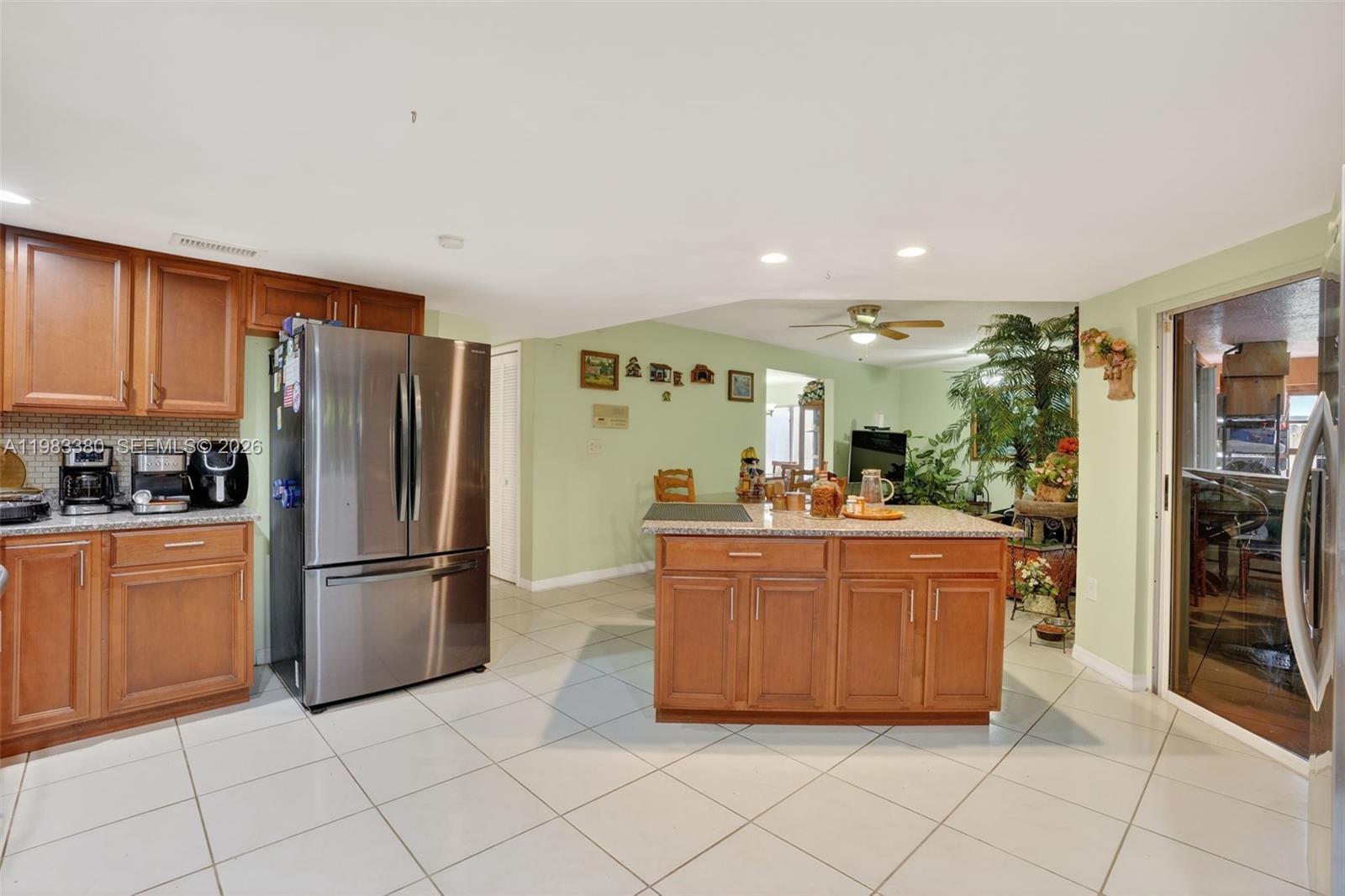 15672 Southwest 91st Lane Miami, FL 33196 - Photo 20 of 47 a large kitchen with stainless steel appliances granite countertop a refrigerator a sink and a stove