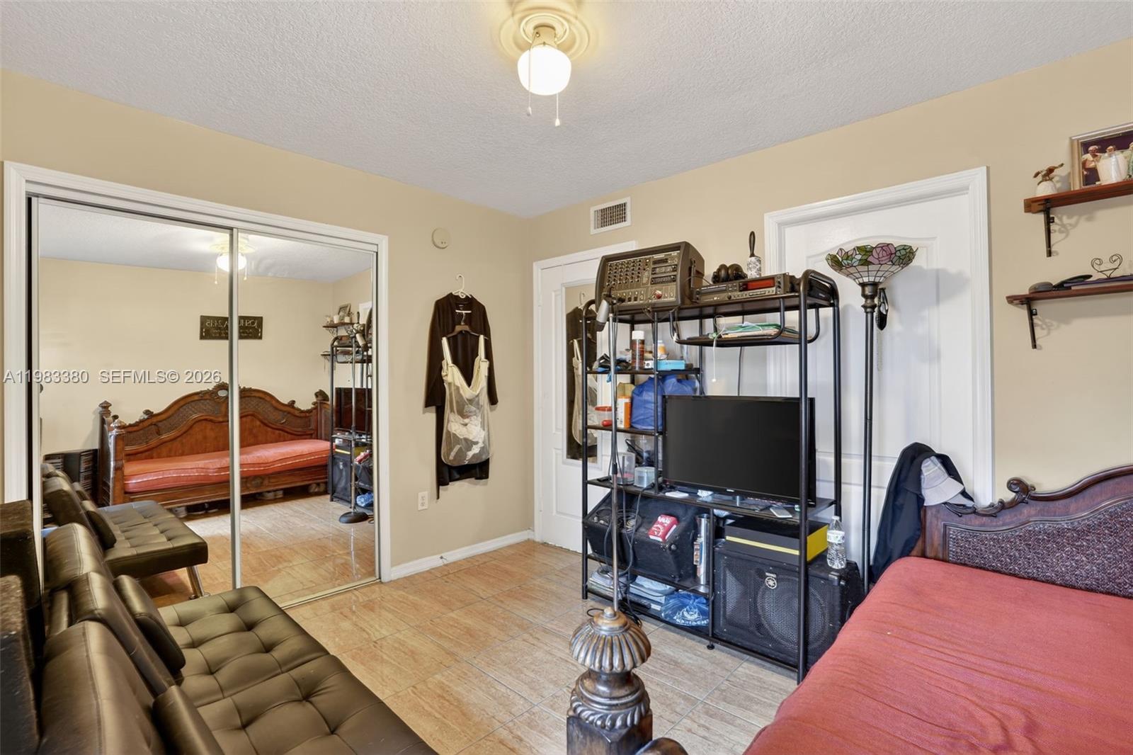 15672 Southwest 91st Lane Miami, FL 33196 - Photo 24 of 47 a bedroom with furniture a flat screen tv and a view of bedroom