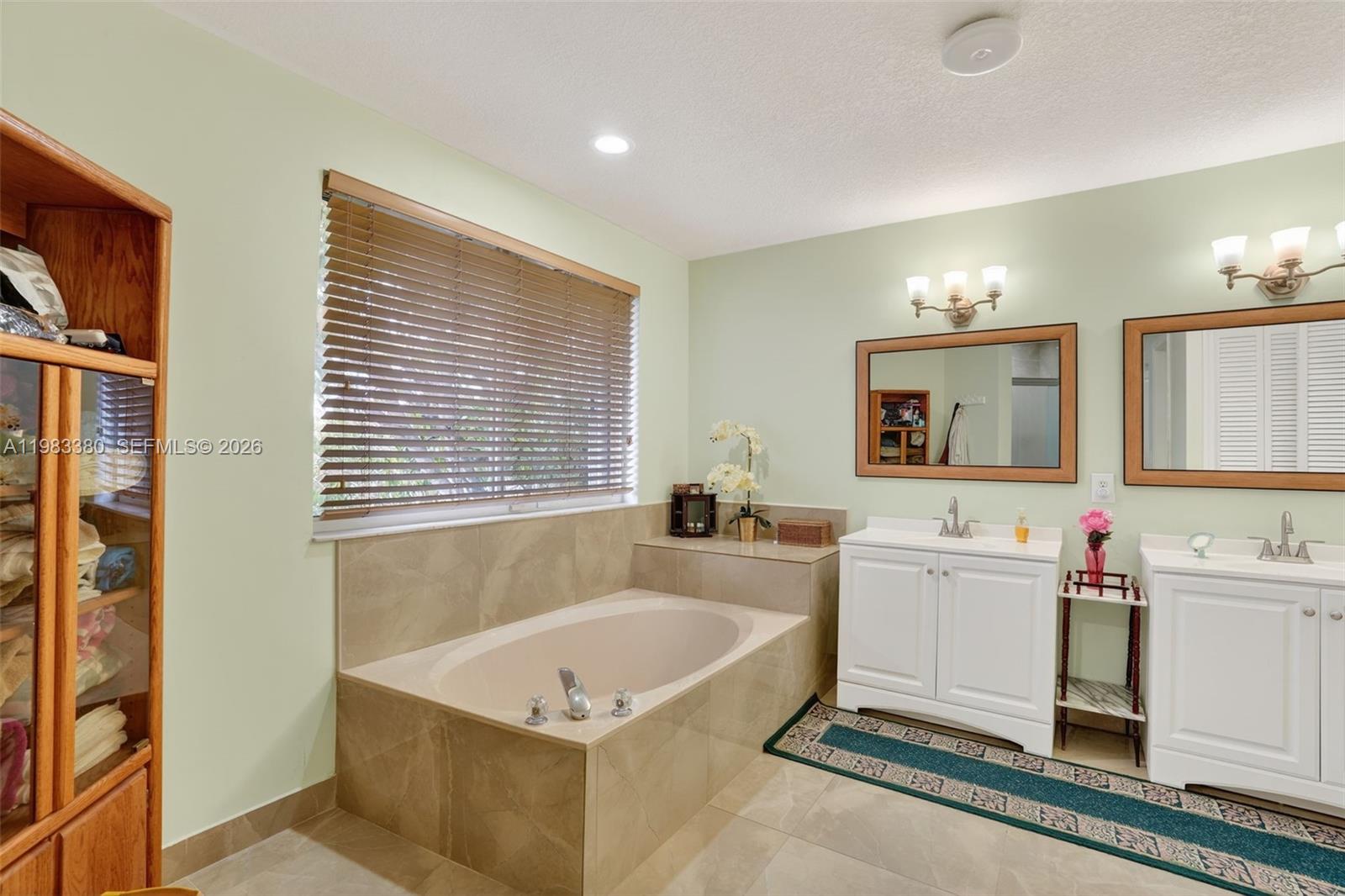 15672 Southwest 91st Lane Miami, FL 33196 - Photo 28 of 47 a spacious bathroom with a tub sink and mirror