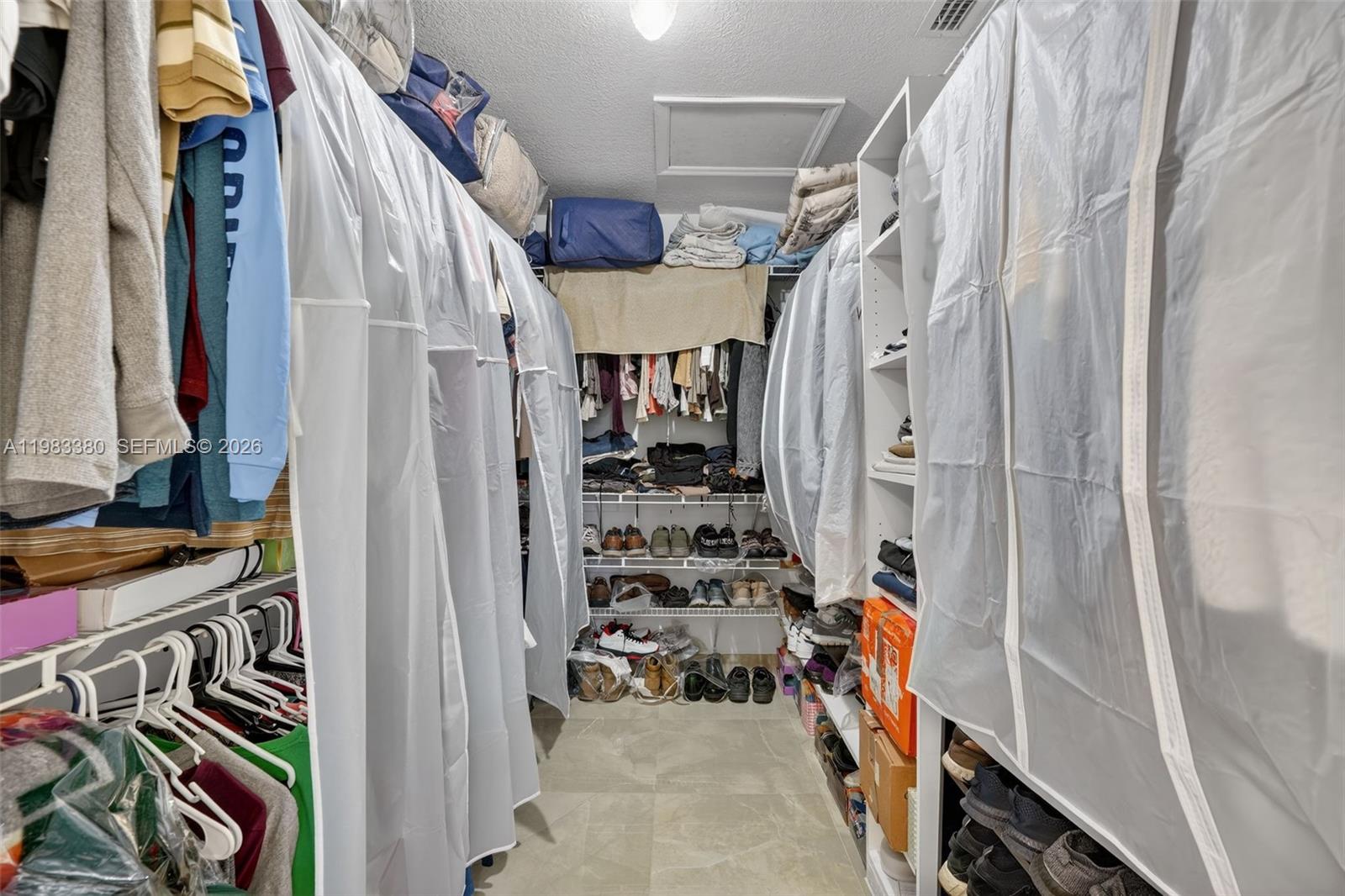 15672 Southwest 91st Lane Miami, FL 33196 - Photo 30 of 47 a view of walk in closet with clothes and shoes