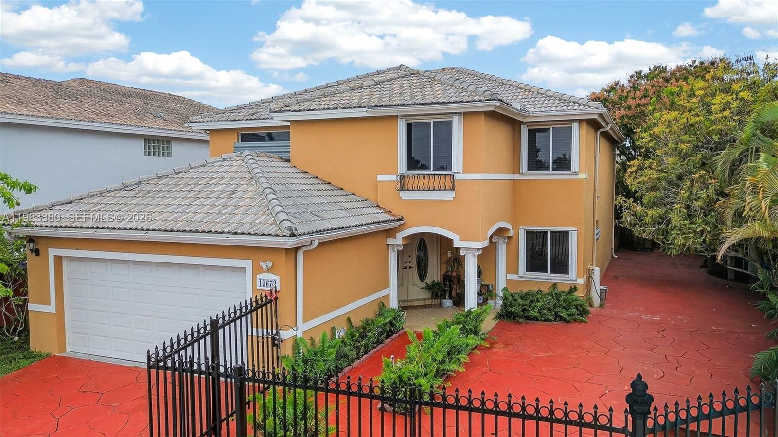 15672 Southwest 91st Lane Miami, FL 33196 - Photo 3 of 47 a front view of a house with entryway