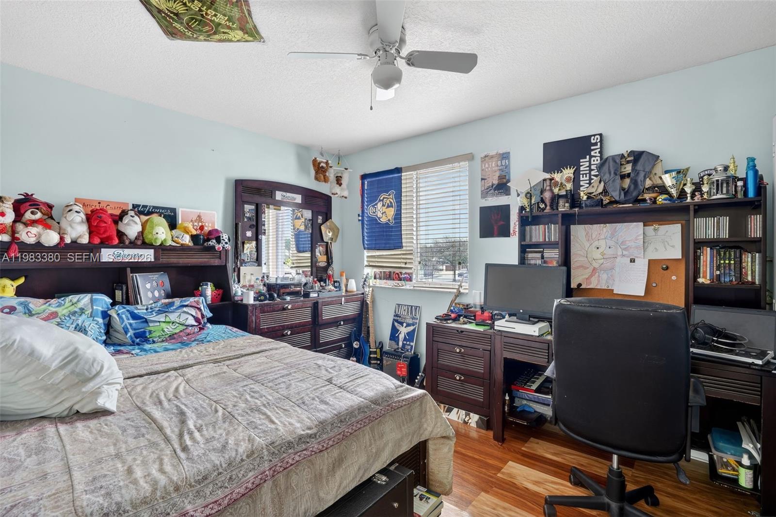 15672 Southwest 91st Lane Miami, FL 33196 - Photo 33 of 47 a bedroom that has a bed and a desk in it