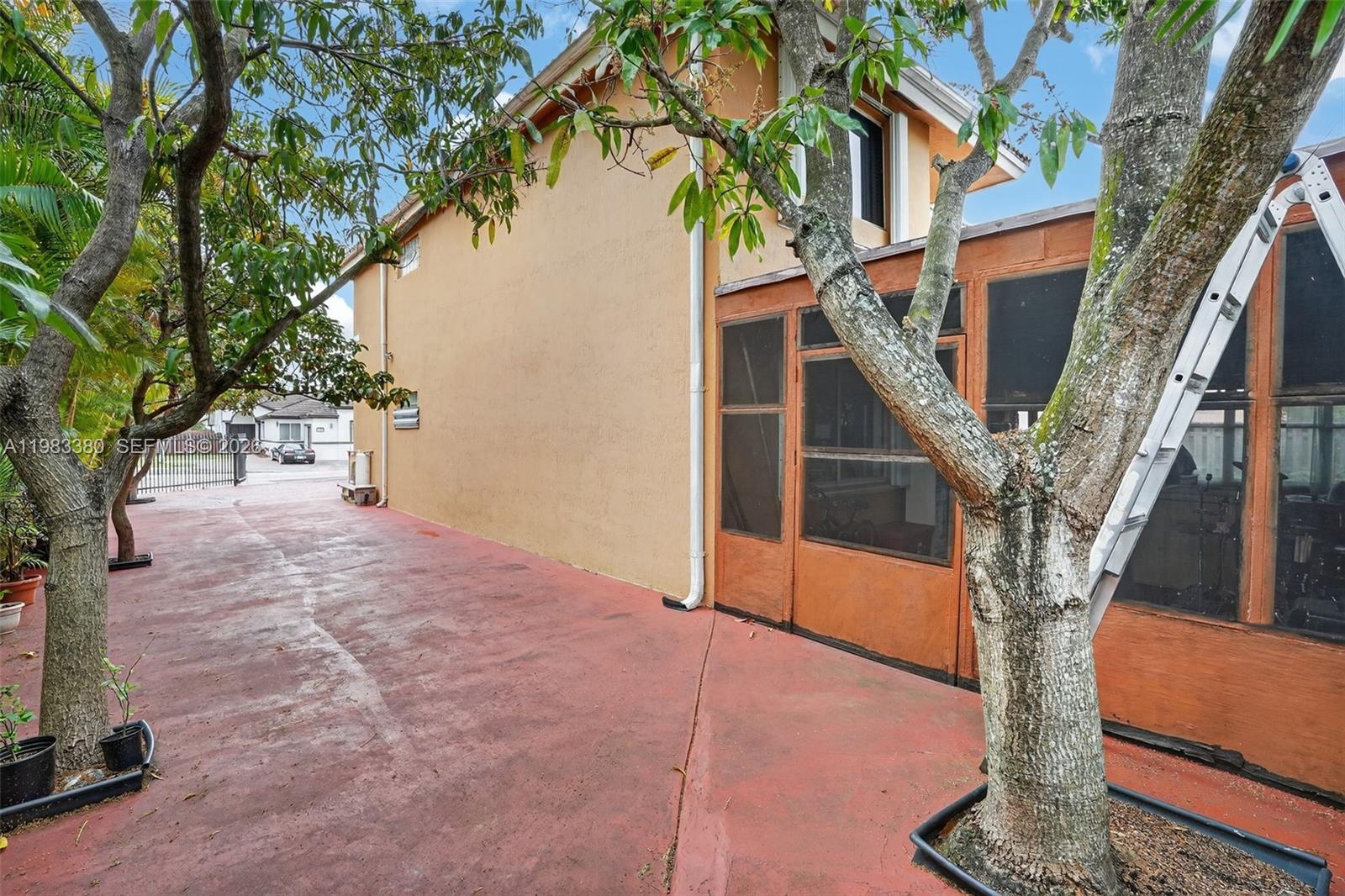 15672 Southwest 91st Lane Miami, FL 33196 - Photo 39 of 47 a porch with lots of green space