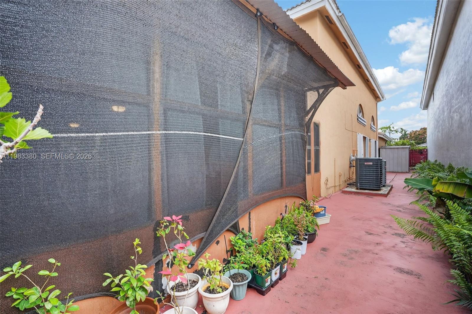 15672 Southwest 91st Lane Miami, FL 33196 - Photo 42 of 47 a garden with flowers in front of main door