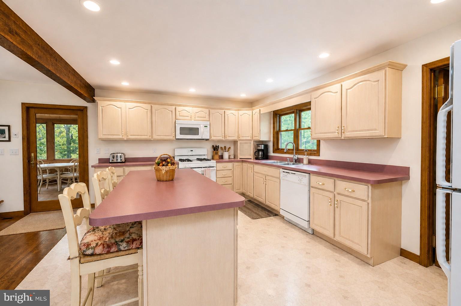 389 Sawmill Hollow Road Swanton, MD 21561 - Photo 13 of 62 a kitchen with stainless steel appliances granite countertop a stove top oven a sink dishwasher and white cabinets with wooden floor