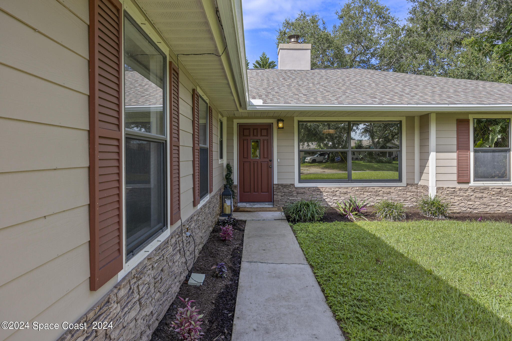 3725 Laurette Road Merritt Island, FL 32952 - Photo 2 of 46 a view of a brick house with a yard next to a road