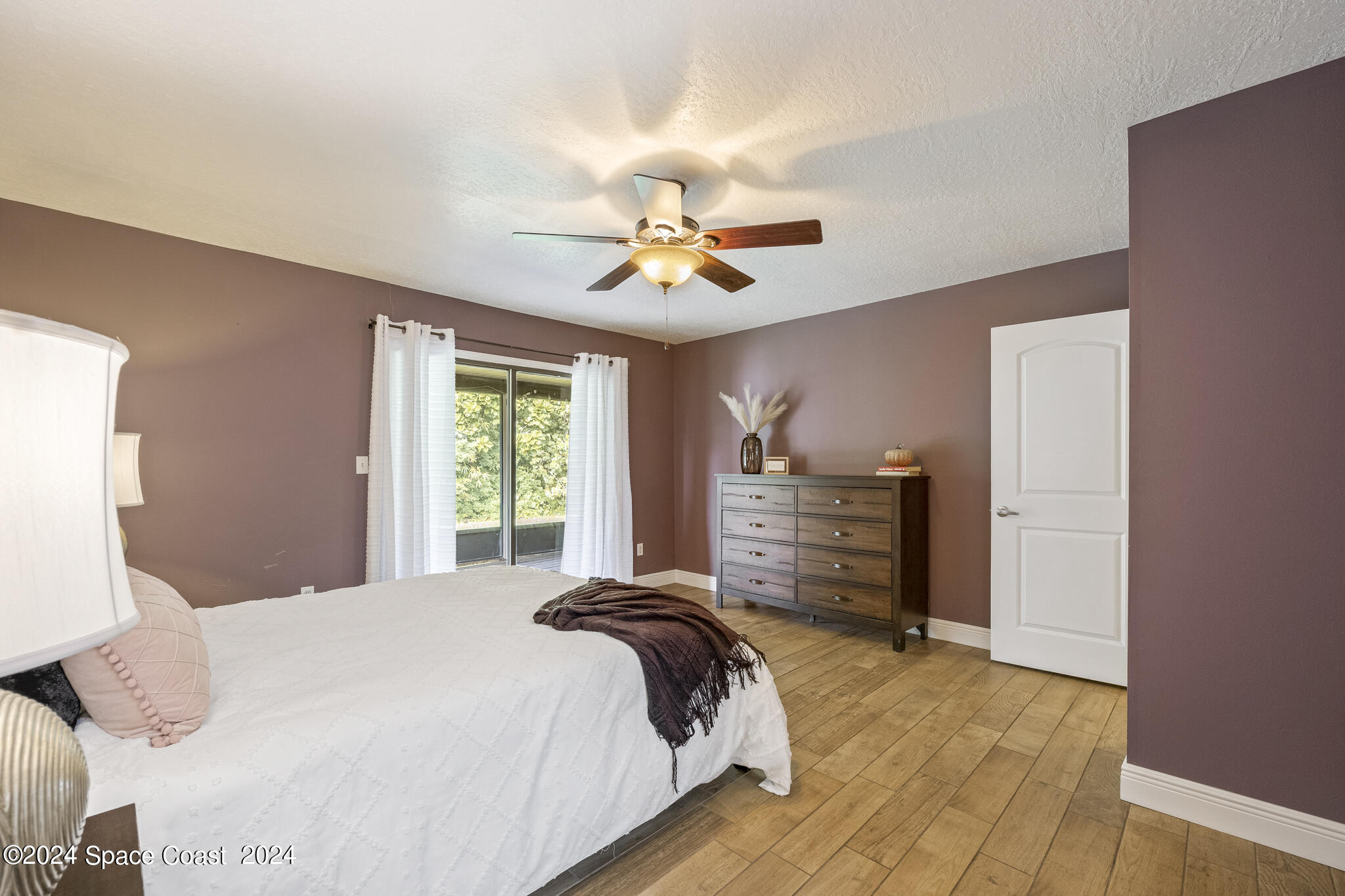 3725 Laurette Road Merritt Island, FL 32952 - Photo 21 of 46 a bedroom with a bed and a chandelier
