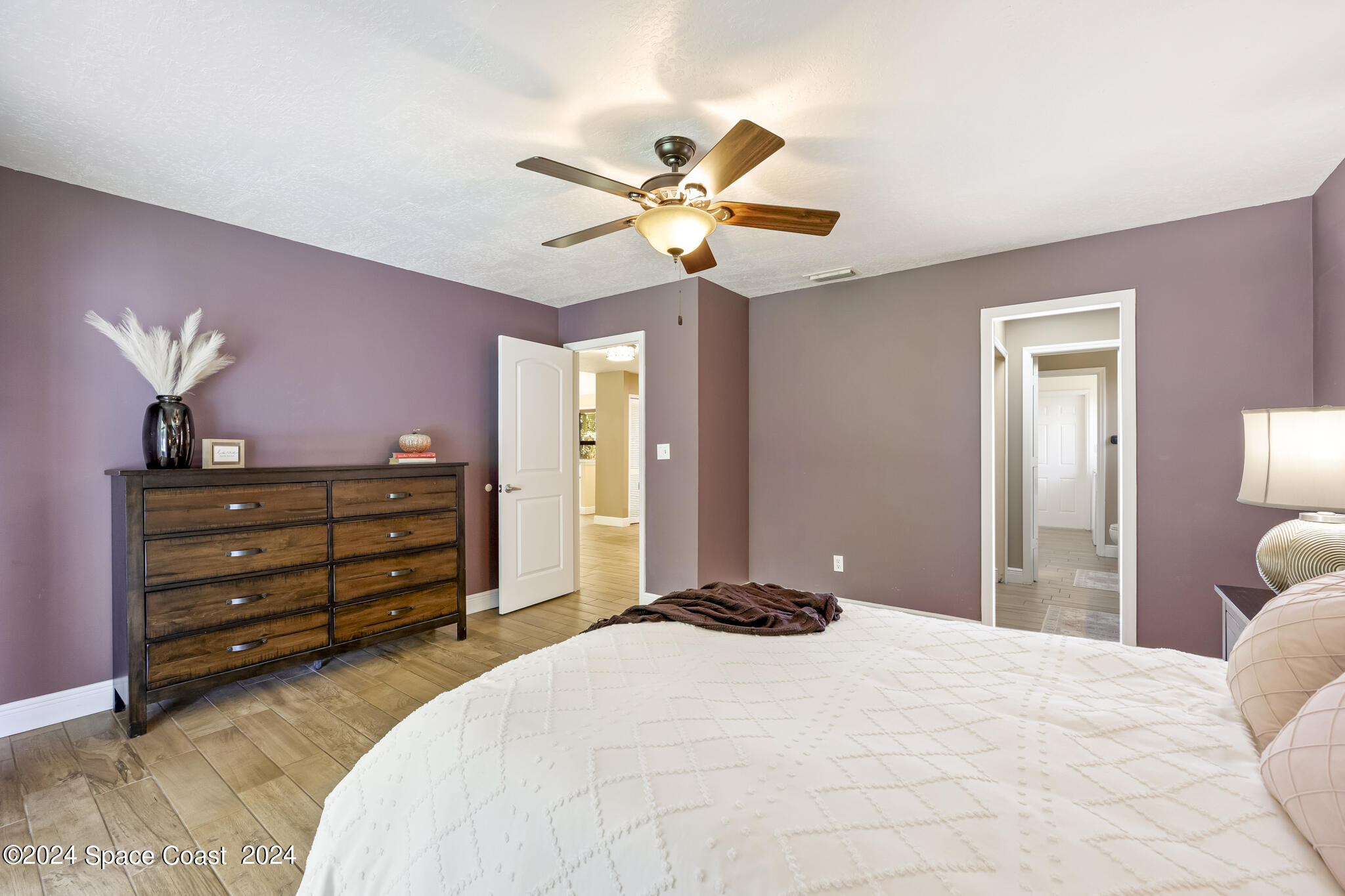 3725 Laurette Road Merritt Island, FL 32952 - Photo 22 of 46 a bedroom with a bed and a chandelier