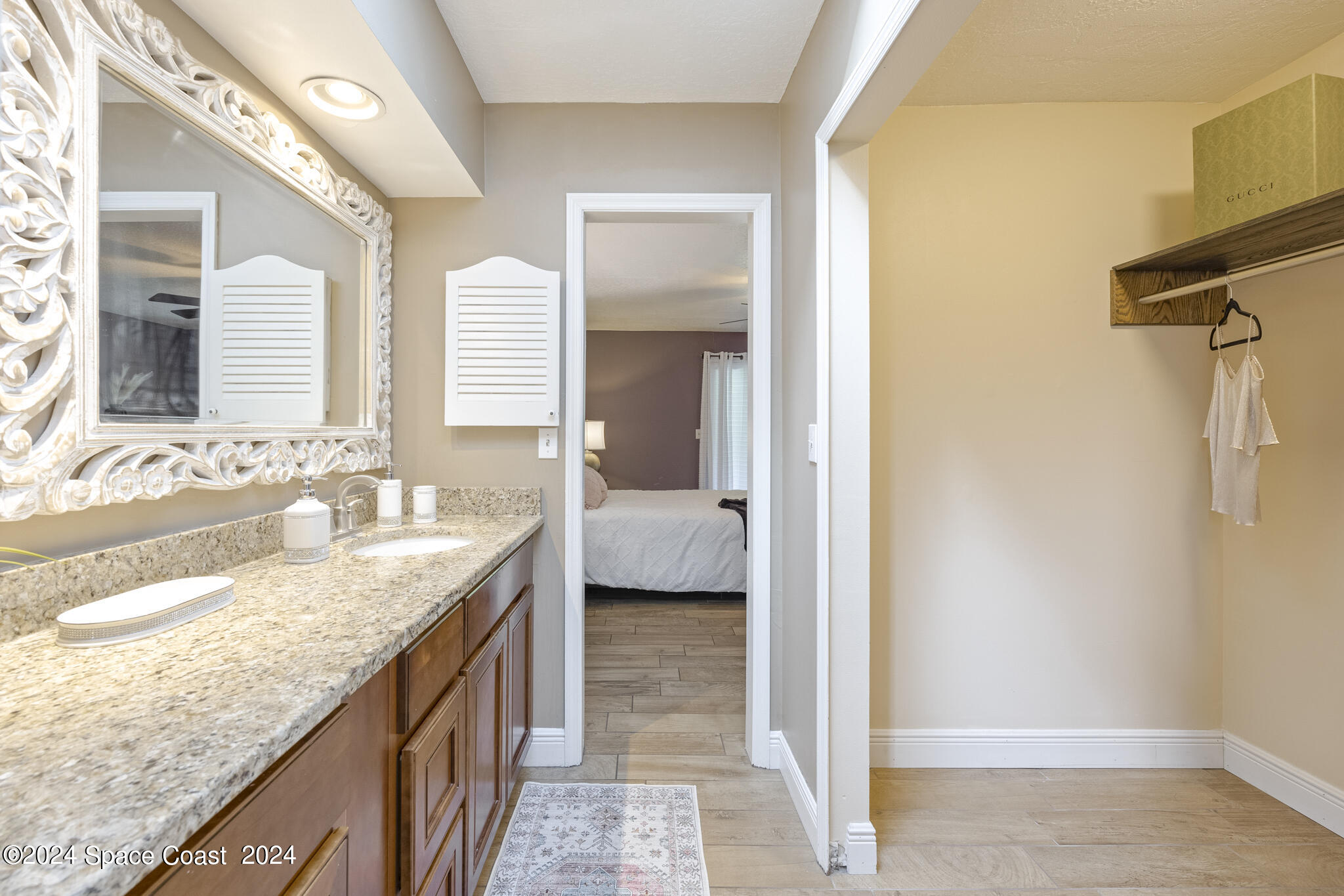 3725 Laurette Road Merritt Island, FL 32952 - Photo 24 of 46 a en suite bathroom with a granite countertop sink and a mirror