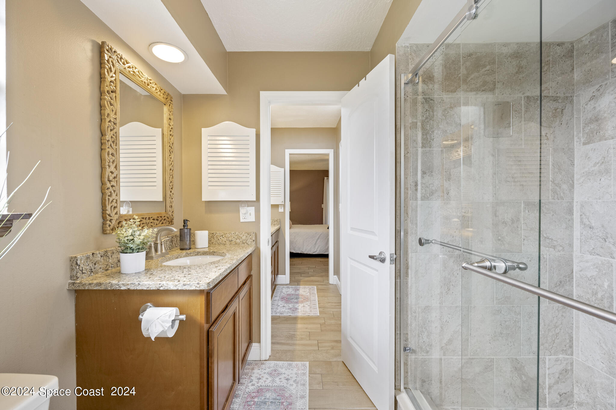 3725 Laurette Road Merritt Island, FL 32952 - Photo 25 of 46 a bathroom with a double vanity sink a mirror and a shower