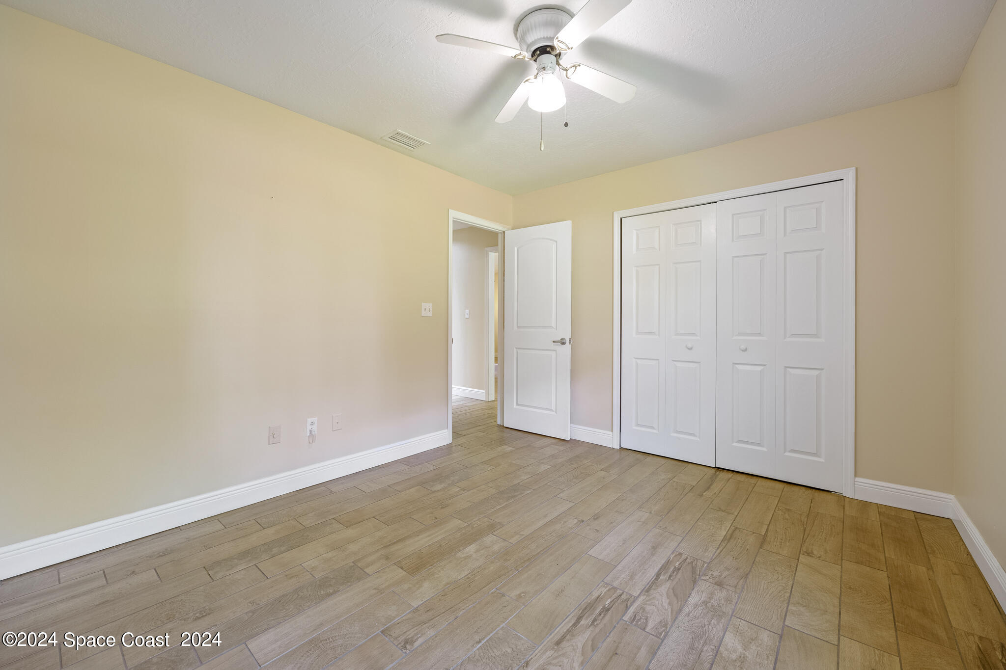 3725 Laurette Road Merritt Island, FL 32952 - Photo 29 of 46 an empty room with a ceiling fan and carpet