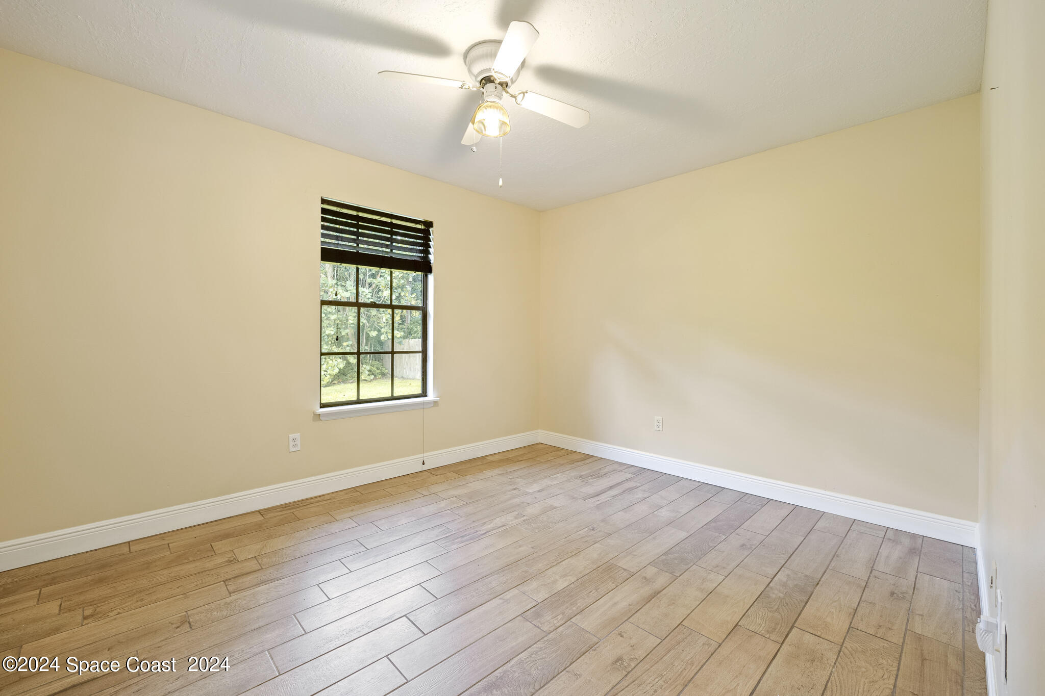 3725 Laurette Road Merritt Island, FL 32952 - Photo 30 of 46 wooden floor in an empty room with a window